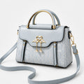 Velora – Swan-Clasp Structured Crossbody Bag with Gold Hardware